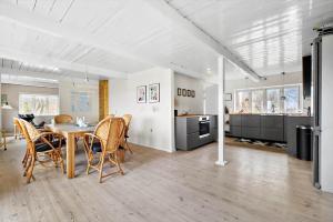 a kitchen and dining room with a table and chairs at 20622-Samso-Skolebakkevej-38 in Brundby