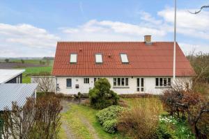 a white house with a red roof at 20622-Samso-Skolebakkevej-38 in Brundby