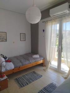 a bedroom with a bed and a large window at Paulina's House in Politika