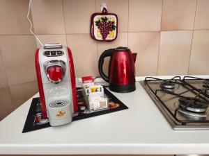 a kitchen counter with a coffee maker and a toaster at Casa Milvia in Bolsena
