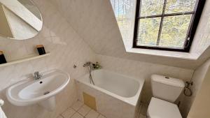a white bathroom with a sink and a toilet at Motel Dareon in Náchod +25 photos