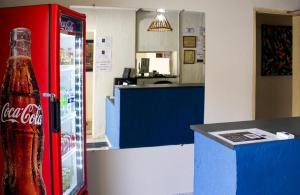 a coca cola bottle sitting in a soda machine at Hospedaria Barão in Campinas +38 photos