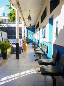 a row of chairs lined up in a hallway at Hospedaria Barão in Campinas