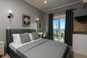 a bedroom with a bed with a view of the ocean at Dimitreli Venetia Studios in Koinyra