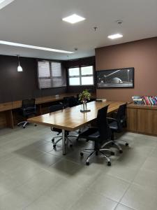 an office with a large wooden table and chairs at Lake view in Brasília +43 photos