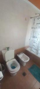 a bathroom with a toilet and a bidet at Mountain, espectacular departamento con vista súper funcional in Ushuaia +9 photos