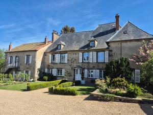 a large stone house with a yard at La Bâtisse de Bromont in Bromont-Lamothe