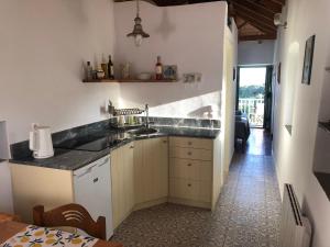 a kitchen with a sink and a counter top at To Ampeli in Potamós