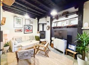 a living room with a couch and a table and a tv at LITTLE TOWER in Potes