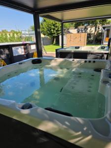 a hot tub filled with green water in a truck at Inter Hotel in Debrecen