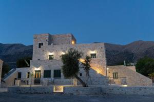 a large stone building with a tree in front of it at Mani Tsopakas Residences Nest studio in Kafióna