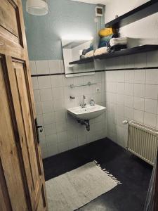 a bathroom with a sink and a mirror at Stadtwohnung Mettmann in Mettmann +13 photos