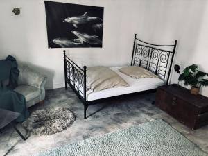 a bedroom with a bed and a couch and a chair at Stadtwohnung Mettmann in Mettmann