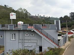 a building with a staircase on the side of it at Revival Villa in Coonoor +7 photos