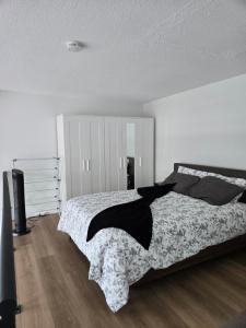 a bedroom with a bed with a black and white blanket at New York Style Loft in Downtown Vancouver in Vancouver