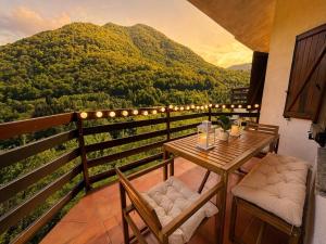 a table and chairs on a balcony with a view at The Terrace Overlooking Lake Como in Muronico