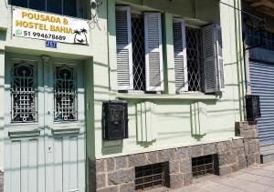 a building with a sign on the side of it at Hostel & Coffe Bahia in Porto Alegre