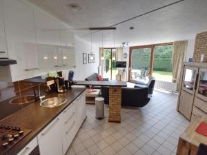 a kitchen and living room with a couch and a table at Rustpunt in Brouwershaven