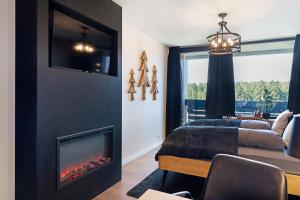 a living room with a fireplace and a couch at Forest Elegance in Freudenstadt