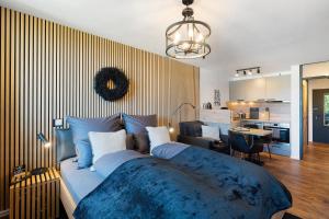 a bedroom with a large bed with a blue blanket at Forest Elegance in Freudenstadt