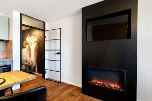 a living room with a fireplace and a table at Forest Elegance in Freudenstadt