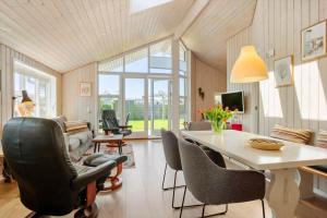 a living room with a dining room table and chairs at FY417-Assens-Glentevej-8 in Næs