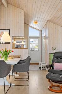 a living room with a dining room table and chairs at FY417-Assens-Glentevej-8 in Næs