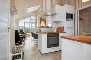 a kitchen with white appliances and a dining room at FY417-Assens-Glentevej-8 in Næs +15 photos