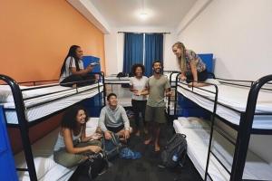 a group of people standing in a room with bunk beds at The European House Pattaya in North Pattaya