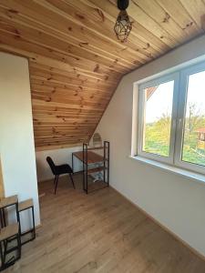 a room with a desk and a window at Dom Pod Niebem in Świętajno