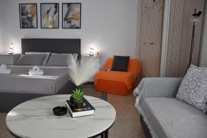 a living room with a bed and a table and a couch at Castle View in Samothraki