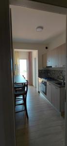 a kitchen with a table and a dining room at Roccazzo 16 in Cefalù