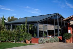 a building with a lot of windows and plants at Locanda Rossa in Capalbio