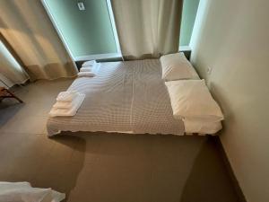 a bed in a room with two pillows on it at Iriki Loft, ένας ατμοσφαιρικός ρετρό χώρος στην Μυτιλήνη in Mytilene