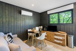 a living room with a couch and a tv at Cabane Spa-Truffiers-Proche Sarlat in Jayac