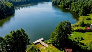 an aerial view of a river with a statue in the middle at Ostoja Tobołowo in Tobołowo
