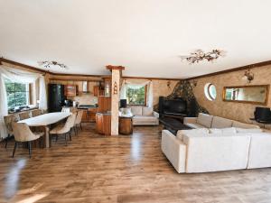 a living room with a couch and a table at Ostoja Tobołowo in Tobołowo +15 photos