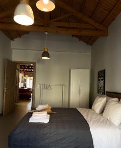 a bedroom with a large bed with towels on it at Iriki Loft, ένας ατμοσφαιρικός ρετρό χώρος στην Μυτιλήνη in Mytilene