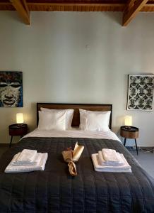 a bedroom with a bed with two towels on it at Iriki Loft, ένας ατμοσφαιρικός ρετρό χώρος στην Μυτιλήνη in Mytilene
