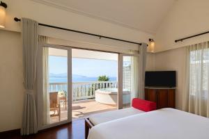 a bedroom with a bed and a balcony with a tub at Centara Villas Phuket in Karon Beach +54 photos