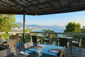 a restaurant with a view of the water at Centara Villas Phuket in Karon Beach