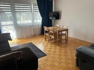 a living room with a table and chairs and a couch at Włocławek Norwida in Włocławek