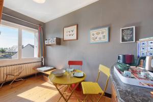 a kitchen with a table and chairs in a room at Chez Fred proche plage et gr34 in Plougoulm +21 photos