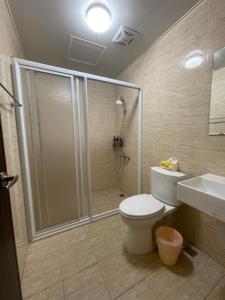 a bathroom with a shower and a toilet and a sink at 哈樓民宿二館 in Lukang +23 photos