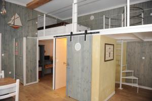 a loft bed in a room with a bunk bed at THE BOAT - Apartamento Temático in Seixal +27 photos