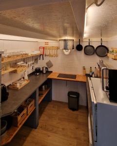 a large kitchen with a counter and a counter top at THE BOAT - Apartamento Temático in Seixal