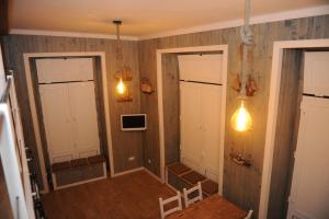 a hallway with two doors and two lights at THE BOAT - Apartamento Temático in Seixal