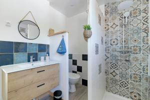 a bathroom with a sink and a toilet and a shower at Gîte De L'etrie in Mauves-sur-Loire +19 photos