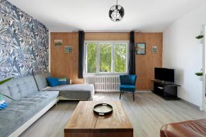 a living room with a couch and a tv at Gîte De L'etrie in Mauves-sur-Loire