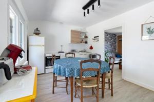 a kitchen and dining room with a table and chairs at Gîte De L'etrie in Mauves-sur-Loire